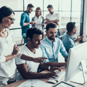 people working together on a computer in an improving work environment