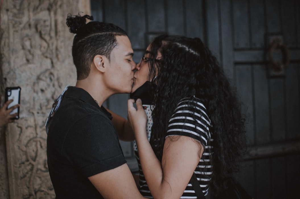 couple with mask kissing