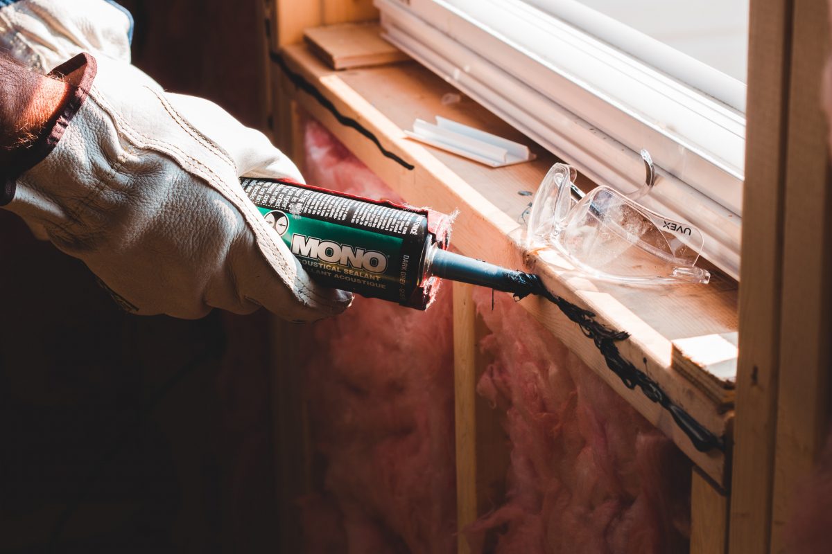 person holding a green and white glue gun