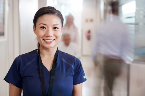 female nurse smiling in a busy hospital