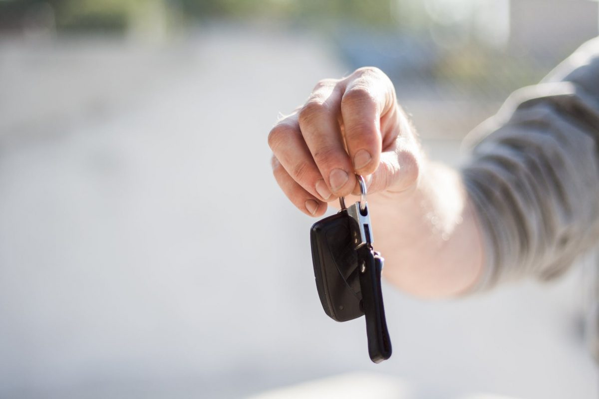man holding keys to car