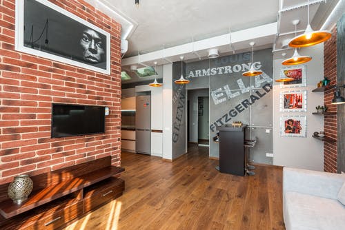 sitting area with brick wall and wood floor
