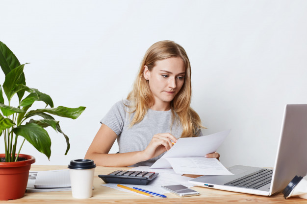 young woman working with laptop on desk