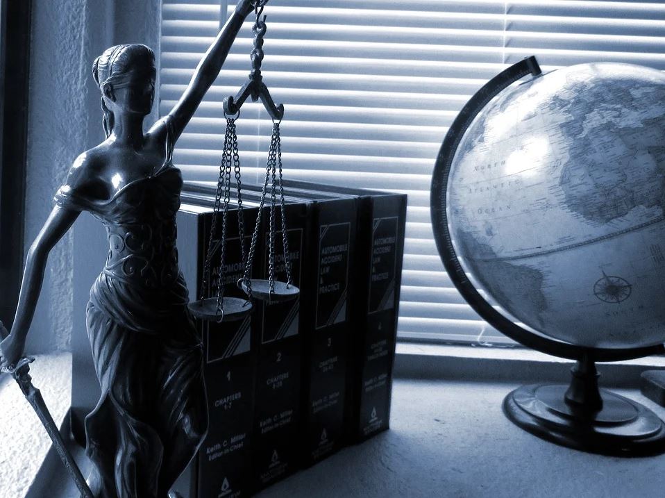 lady justice with globe on desk