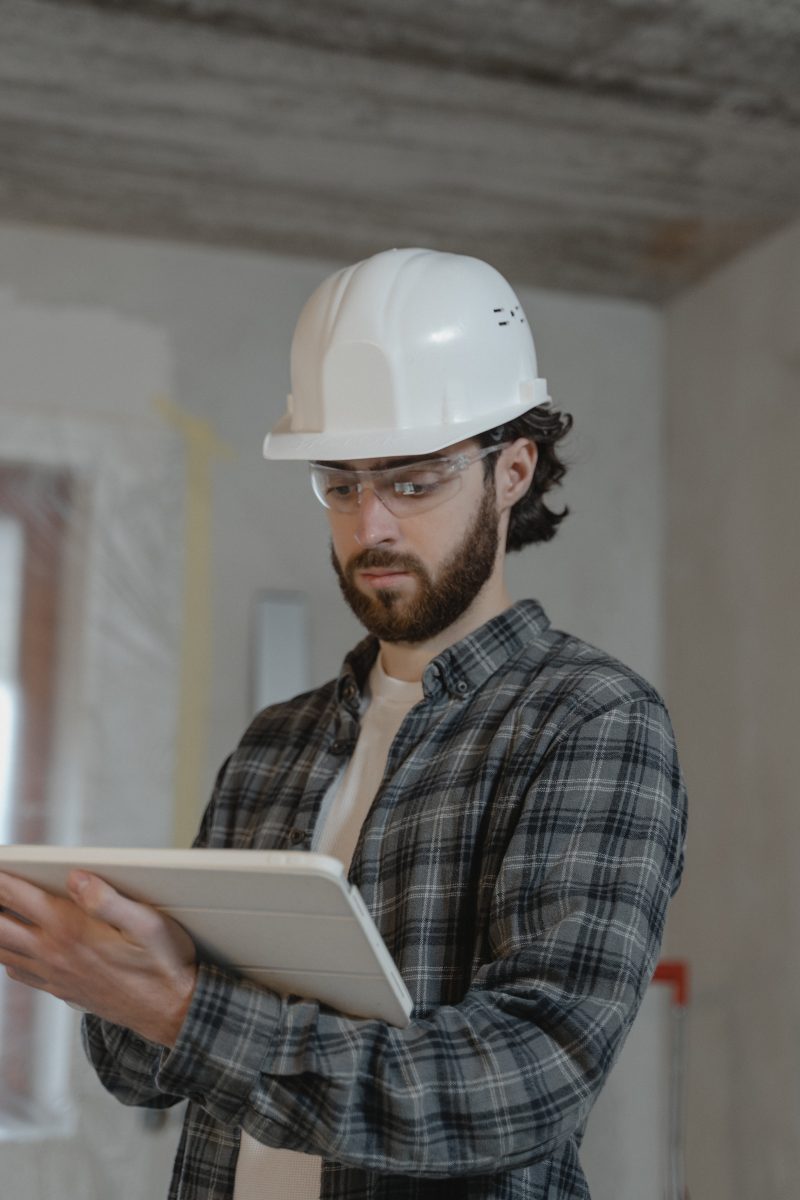 man in plaid shirt wearing a hard hat