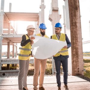 three architects looking at drawing of plan