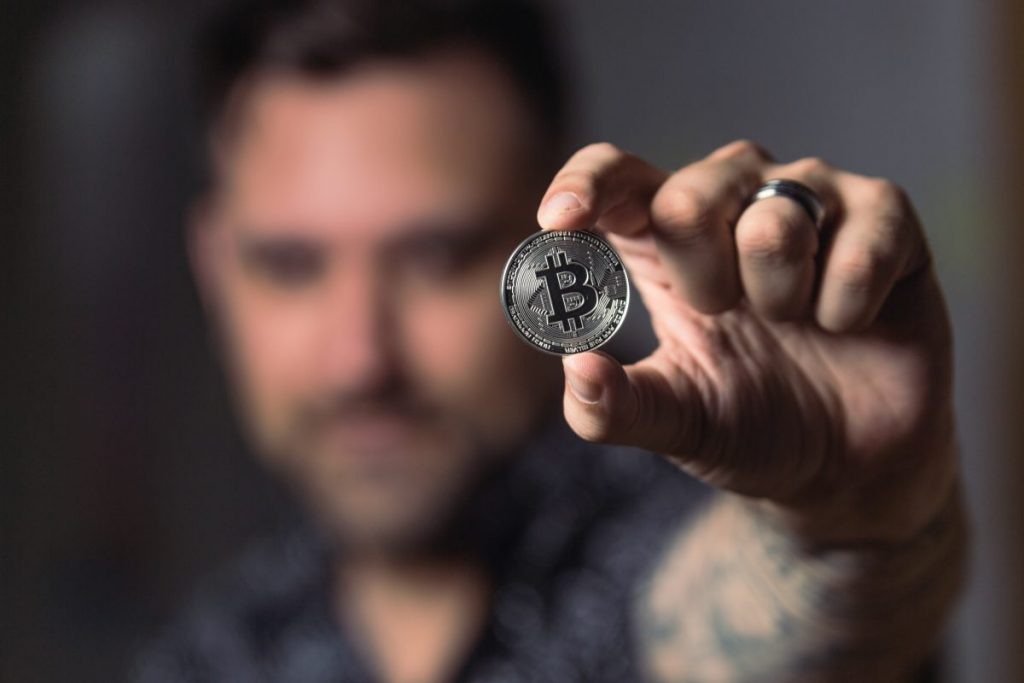 man holding a bitcoin
