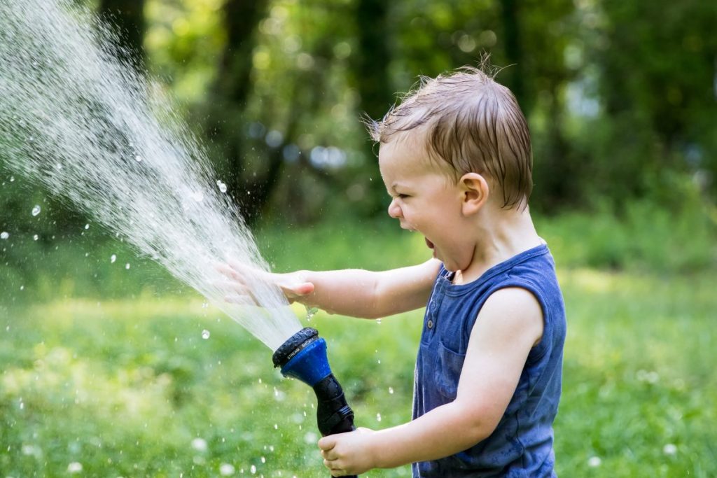 child and waterhose