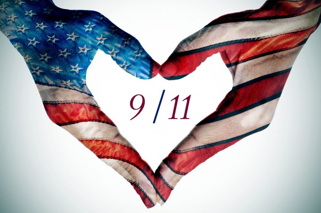 9/11 with hands shaped as heart and painted like american flag