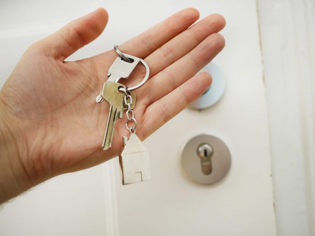 person holding keys to a brand new house