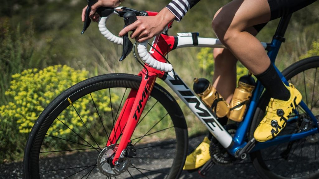 person riding a bike near grass