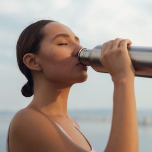 girl drinking out of a thermas