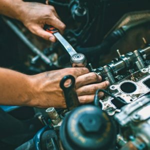 mechanic working on car engine