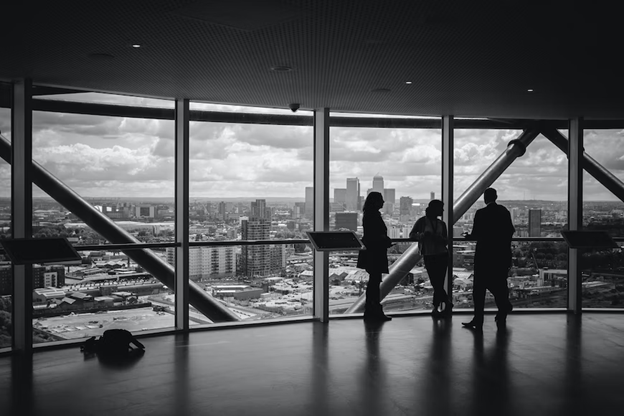 A group of people standing by large windows