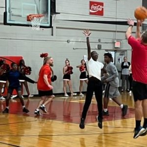 Jr. high students play teachers in basketball game