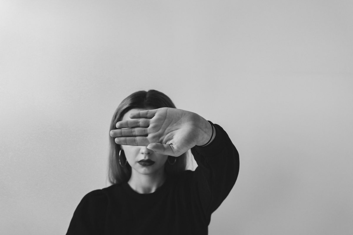 Black and white lady with hand in her face