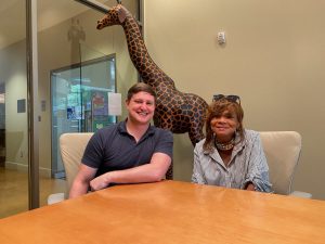 Programs and activities to attract all ages to the library are discussed by Jami Pittman, Clinton-Quisenberry Library branch manager, and Anne Sanders, Jackson Hinds Library System program and partnership coordinator. They are shown in the Giraffe Room.