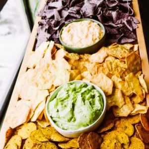 A fun New Year's Eve gathering idea is to create a charcuterie board filled with a variety of dips, chips and crackers.