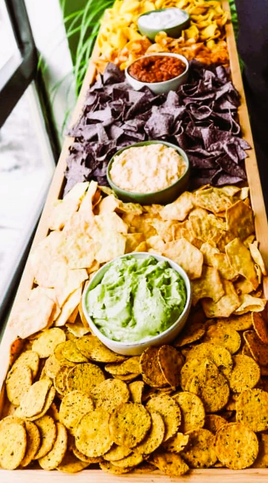 A fun New Year's Eve gathering idea is to create a charcuterie board filled with a variety of dips, chips and crackers.