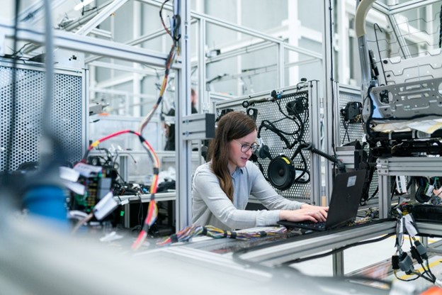woman with glasses working on a computer in a testing laboratory