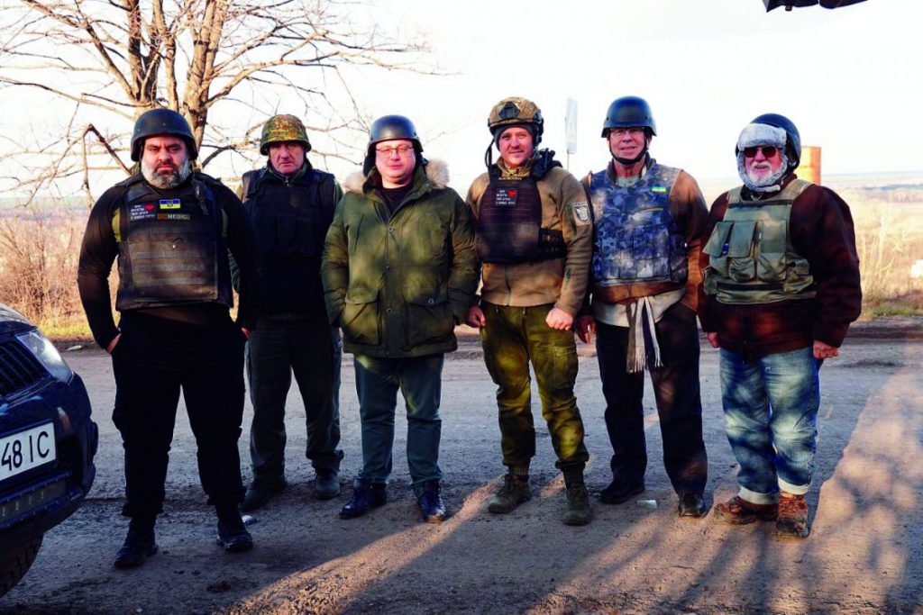 Dressed for the war zone frontline and cold weather, Pastor Oleg Gricyk, Russell Kyzar, and Bob Gilmore meet soldiers and medics. 