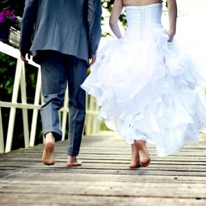 bride and groom walking across a bridge in Mississippi