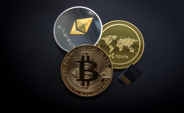 a group of coins (cryptocurriences) with a microchip on black background