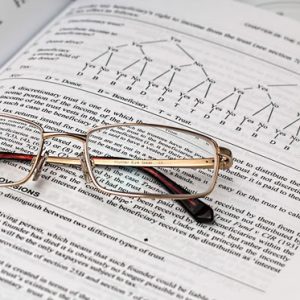 glasses sitting on tax books