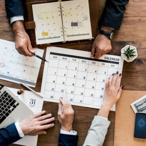 gentleman's hands pointing to calendar in a meeting