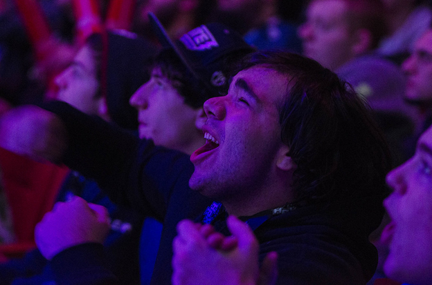man yelling from crowd at esports viewing party