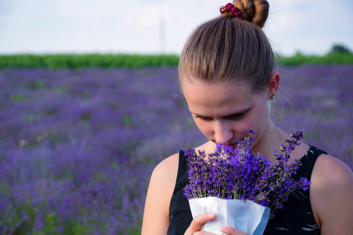 girl holding purple flowers in a field full of purple flowers