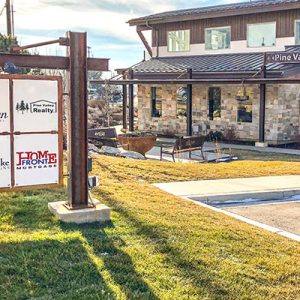 outdoor business signs hanging in front of building