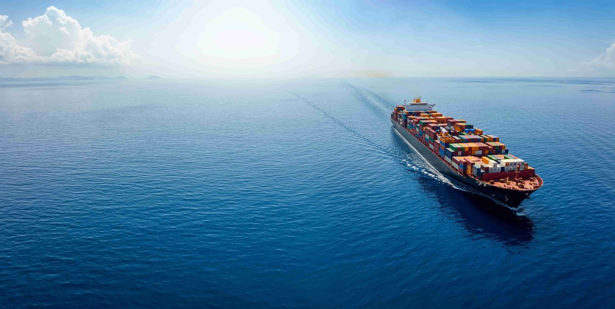 a large ship on the open sea with the sun in the horizon