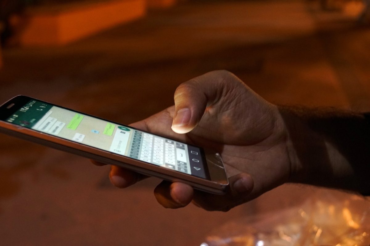 hand holding smart phone with messages 