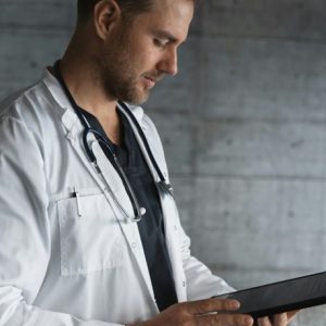 medical doctor looking at tablet
