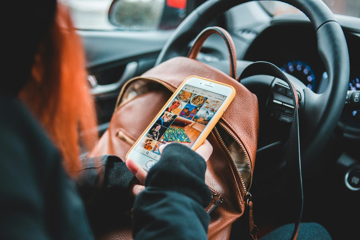 woman surfing social media while sitting in the car