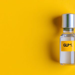 GLP1 in a glass container sitting on yellow background