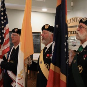 The Knights of Columbus watch the ceremony after presenting the colors at its start.