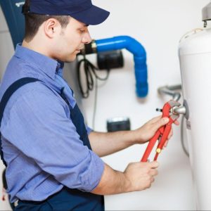 male working on a water heater