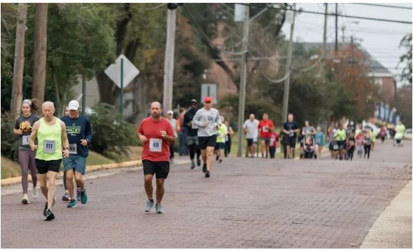 Hap Hudson 5K participants wind through Olde Towne Clinton before ending the race on the Dr. James E. Parkman Track.