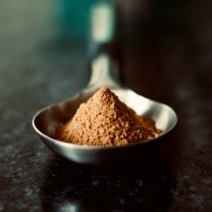 brown powder kratom in a spoon