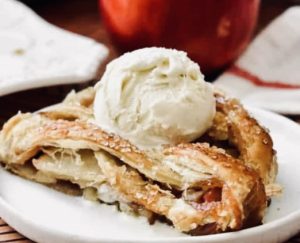 A slice of apple strudel topped with a scoop of vanilla ice cream is the perfect fall treat.