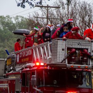 The Clinton Fire Department rides along College Street. The parade brings members of the Clinton community together to ring in the holidays.