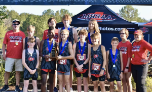 Pictured (l to r) are members of the Clinton Junior High School boys’ cross country team with their coaches, front row: Micah Riggs (alt), Daniel Dolson, Logan Moore, Noah Duncan, Jace Williamson and Micah Kieffer; and back row: Maddox Box, Colton Lay, William Howell, Ezra Connelly and Coleman Finch.