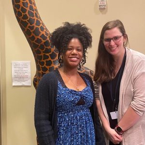 Quisenberry Library branch manager Brittany Moore (left) and staff member Jennifer Burge (right) discuss upcoming library plans for the holiday season in the giraffe room.