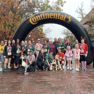 Participants of the 2023 Yule Run post for a picture with their finisher medals.