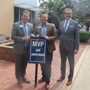 Mississippi College President Blake Thompson, left, presents his DBT's MVP Award for November to Jay Armstrong, center, while MC Law Dean John Anderson observes.