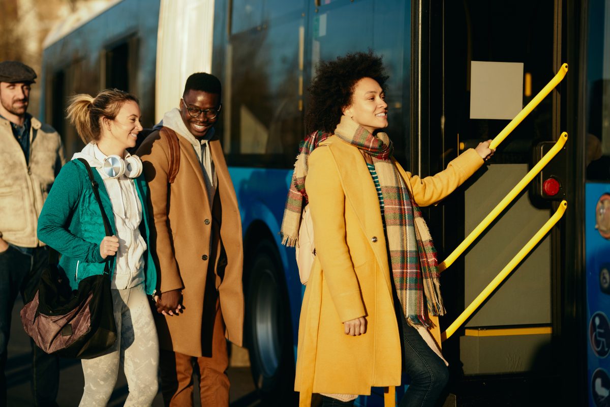 people getting on to a bus