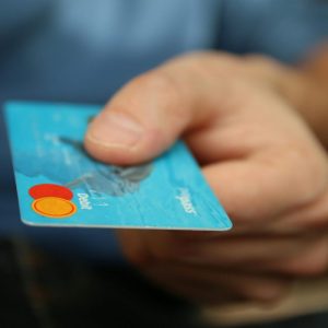 person holding a debit card