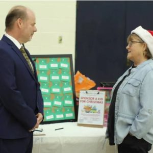 Shari Barnes discusses MC's 'Sponsor a Child' program with Ken Gilliam, MC director of continuing education.